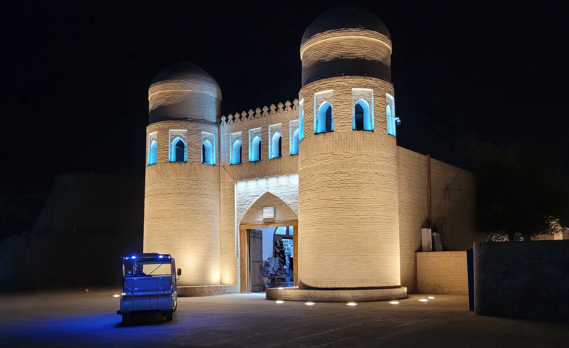 The west gate of Ichan Kala, the walled inner city of Khiva, lit up after dark.
