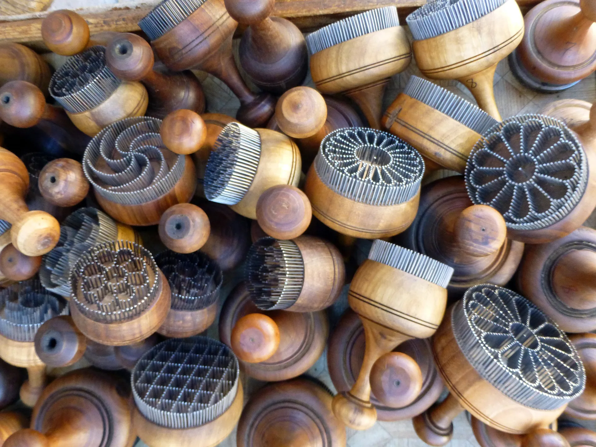 Wooden chekich stamps studded with nails, used to press patterns into non before baking. Every region, and many bakers, have their own.