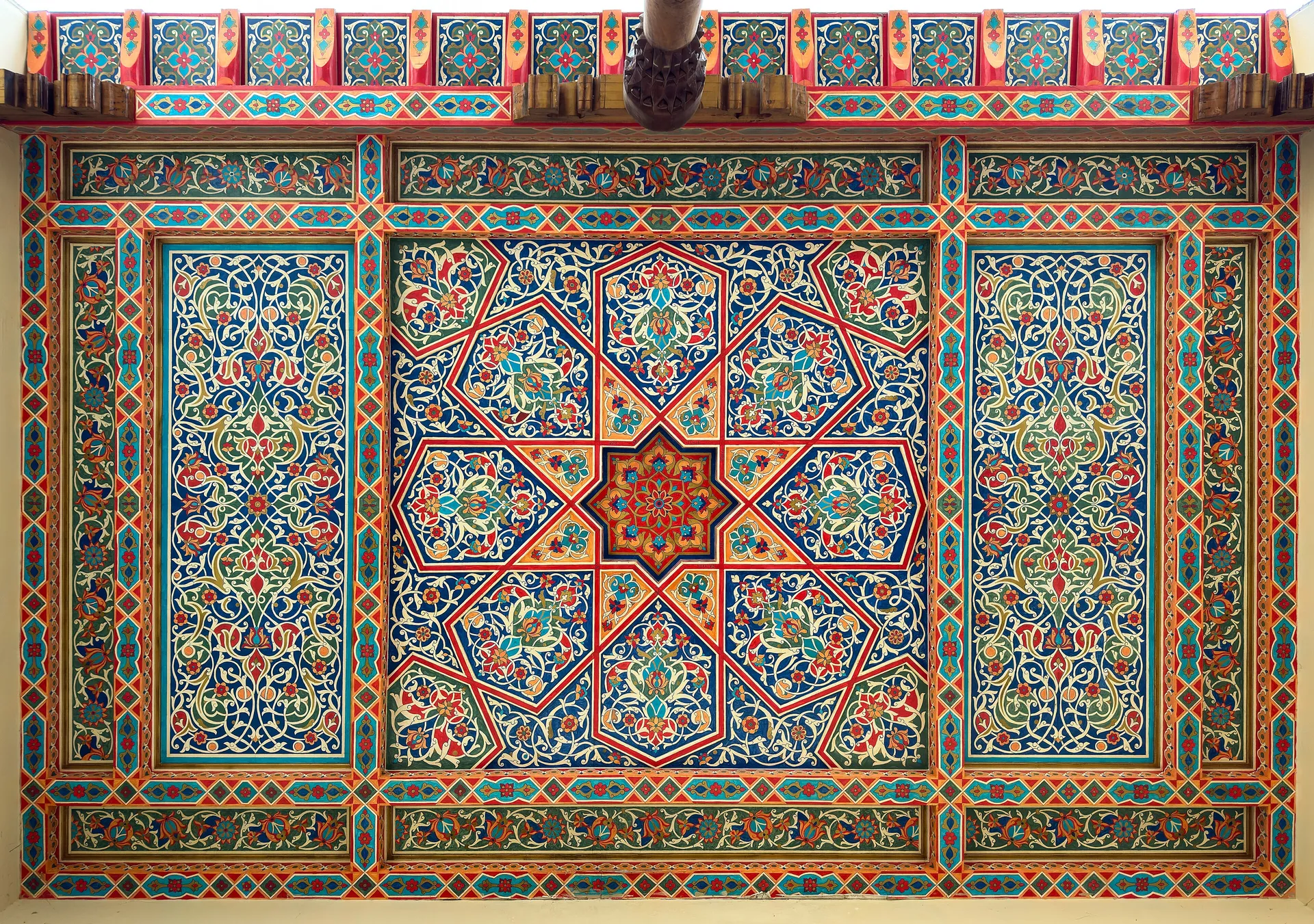 A ceiling painted in the Kokand style at the craftsmen's village in Tashkent's Navruz Park — every panel a different geometric star.