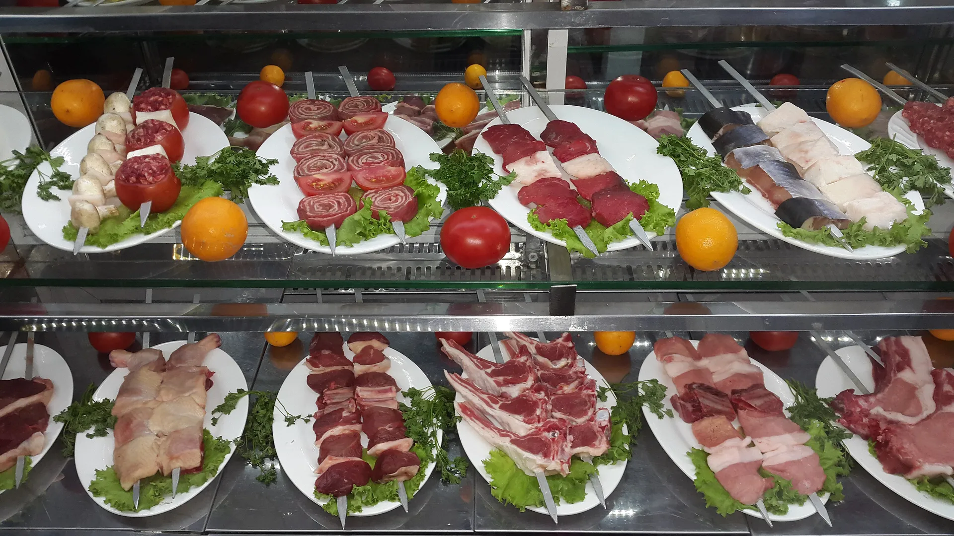 Skewers of lamb, beef, minced meat and liver laid out at a Samarkand grill house, waiting for the charcoal.